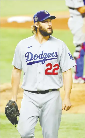  ?? KEVIN JAIRAJ/ USA TODAY ?? Dodgers ace Clayton Kershaw didn't have his best stuff on Sunday, but he battled into the sixth inning of a 4-2 win over Tampa Bay. Los Angeles leads the series 3-2.