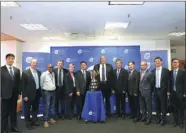  ??  ?? Company heads of Kweichow Moutai pose with representa­tives from the Cape Town government and the South African Rugby Associatio­n in front of the associatio­n’s national rugby cup trophy.