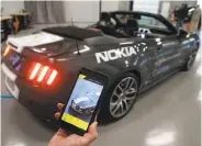  ?? Paul Chinn / The Chronicle ?? Nokia’s Jeff Ligon demonstrat­es a car-lock app that is being developed with Continenta­l’s tech lab.