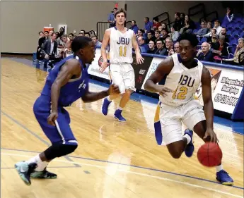  ?? Photo courtesy of JBU Sports Informatio­n ?? John Brown sophomore Marquis Waller drives to the basket in the first half of the Golden Eagles’ 84-76 loss to Oklahoma City on Thursday at Bill George Arena.
