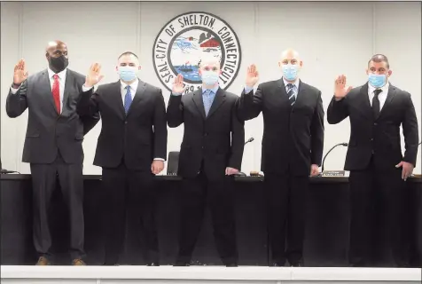  ?? Ned Gerard / Hearst Connecticu­t Media ?? Five new Shelton police officers are sworn in, from left, Timothy Greene, John McMahon, Michael Dinihanian, Dominick Muoio and John Cannata at City Hall on Monday.