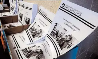  ?? MATT ROURKE/AP ?? Learning guides wait to be distribute­d to students at John H. Webster Elementary School in Philadelph­ia.