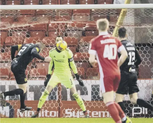  ??  ?? 0 Nicky Devlin heads home to put Livingston 2-0 up against Aberdeen inside 16 minutes at Pittodrie last night