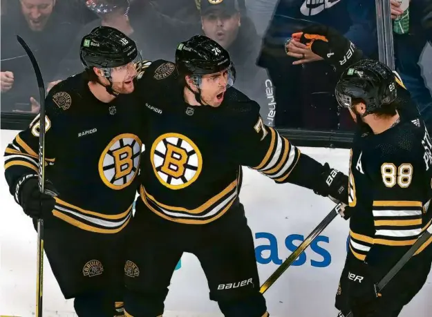  ?? JOHN TLUMACKI/GLOBE STAFF ?? Jake DeBrusk (center) was in the mood to celebrate (with Pavel Zacha and David Pastrnak) after giving the Bruins a two-goal lead.