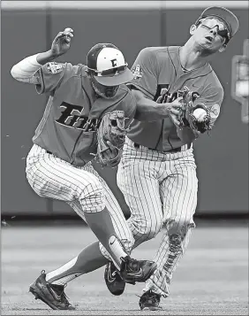  ?? RYAN SODERLIN/OMAHA WORLD-HERALD VIA AP ?? Cal State Fullerton’s Sahid Valenzuela, left, and Scott Hurst collide as Hurst catches a ball hit by Oregon State’s Elliott Cary in the fourth inning of Saturday’s College World Series opener in Omaha, Neb. Oregon State rallied for a 6-5 victory.