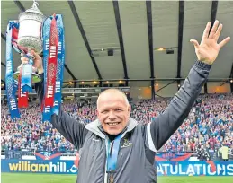  ??  ?? The spoils: Inverness manager John Hughes celebrates with the trophy