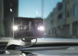  ??  ?? Owl Cameras CEO Andy Hodge, top, is seen on a video feed that the dashboard unit, above, sends to a smartphone. The device, illuminate­d with LED lights, has both front- and rear-facing cameras.