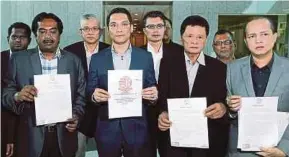  ?? PIC BY FARIZ ISWADI ISMAIL ?? Jaringan Melayu Malaysia president Datuk Azwanddin Hamzah (fourth from left) and JMM members showing copies of the memorandum, which were handed to the Registry of Societies in Putrajaya yesterday.