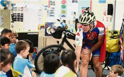  ??  ?? Hodson in his superhero outfit, regaling young learners about his cycling adventures around the world.