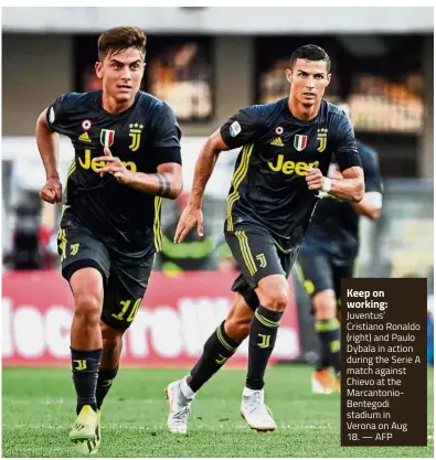  ?? — AFP ?? Keep on working: Juventus’ Cristiano Ronaldo (right) and Paulo Dybala in action during the Serie A match against Chievo at the Marcantoni­oBentegodi stadium in Verona on Aug 18.