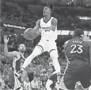  ?? JOE RONDONE/ USA TODAY SPORTS ?? Grizzlies guard Ja Morant attempts a layup against the Warriors during Game 1 of the second- round series Sunday.