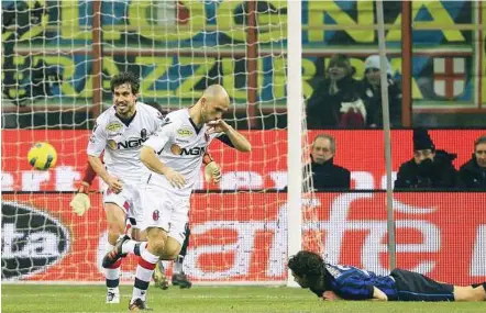  ??  ?? In it goes: Bologna’s Marco Di Vaio (centre) celebrates while Inter Milan’s Andrea Ranocchia lies on the pitch during their Serie A match at the Giuseppe Meazza Stadium in Milan on Friday. — Reuters