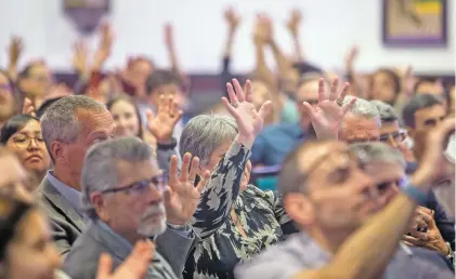  ?? PHOTOS BY LUIS SÁNCHEZ SATURNO/THE NEW MEXICAN ?? People applaud in sign language for Adrien Ercolino, a senior at New Mexico School for the Deaf, while he collected his Super Scholar award Wednesday at a banquet at La Fonda on the Plaza.