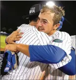  ?? AP ?? Florida outfielder Austin Langworthy (right) hugs Deacon Liput after hitting a walk-off home run in the bottom of the 11th inning Monday.