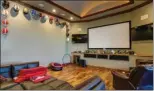  ??  ?? The home offers a variety of living spaces, including this theater room, which opens to the pool area.