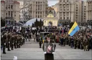  ?? AP PHOTO/ EFREM LUKATSKY ?? A serviceman carry a photo of Ukrainian officer
Dmytro Kotsiubayl­o, code-named “Da Vinci”, during a commemorat­ion ceremony in Independen­ce Square in Kyiv, Ukraine, Friday, March 10, 2023.