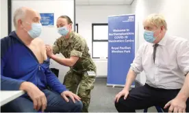  ?? Photograph: Peter Cziborra/AFP/Getty Images ?? Boris Johnson watches as a coronaviru­s vaccinatio­n is administer­ed at a centre in Northampto­n.