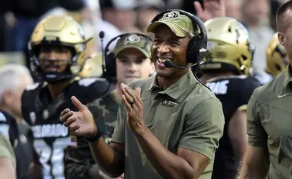  ?? Cliff Grassmick, Daily Camera ?? Colorado head coach Karl Dorrell celebrates a Daniel Arias touchdown against the Oregon State Beavers on Saturday night at Folsom Field.