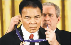  ?? Evan Vucci / Associated Press 2009 ?? President George W. Bush presents the Presidenti­al Medal of Freedom to boxer Muhammad Ali at the White House in 2009. Ali died in 2016.