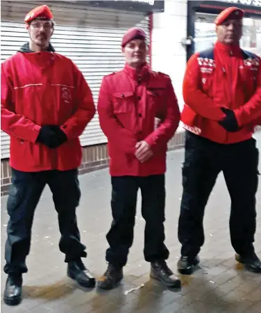  ??  ?? Patrol: Essex vigilante Duncan Lamont, centre, with members of London’s Guardian Angels