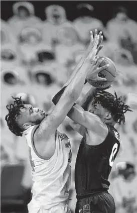  ?? JULIO CORTEZ/AP ?? Michigan State forward Aaron Henry, right, goes up for a shot against Maryland forward Donta Scott during a game Sunday in College Park.