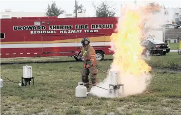  ?? Broward Sheriff’s Fire Rescue ?? In a demonstrat­ion, a Broward firefighte­r lowers a frozen turkey into a a pot of oil in a propane-fueled fryer. At the time, the fire chief said: ‘We urge people who enjoy deep-fried turkey to purchase one prepared by a profession­al.’