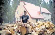  ?? Max Whitaker, © The New York Times Co. ?? Jeffrey Dupras, a firefighte­r for the U. S. Forest Service, discusses the explosive power of recent wildfires last week in his backyard in Quincy, Calif.