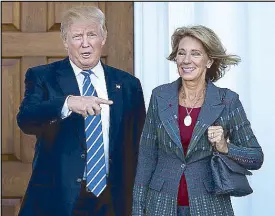  ?? AFP ?? President-elect Donald Trump is shown with Betsy DeVos after their meeting at Trump Internatio­nal Golf Club, in Bedminster Township, New Jersey.