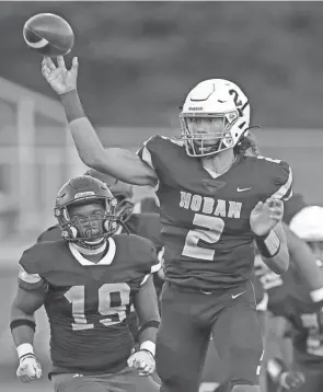  ?? JEFF LANGE/AKRON BEACON JOURNAL ?? Akron Hoban quarterbac­k Jayvian Crable throws a pass against Bishop Sycamore on Aug. 19. Hoban won 38-0.