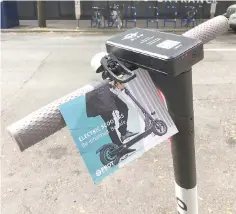  ?? — Photo by Mike Crebs/ Portland Bureau of Transporta­tion ?? In hopes of educating Portland electric scooter riders about local rules of the road, the Portland Bureau of Transporta­tion has turned to a low-tech solution: paper fliers and rubber bands.