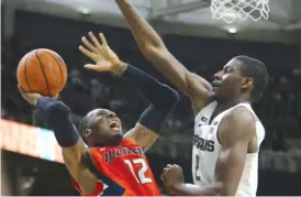  ?? | REY DEL RIO/ GETTY IMAGES ?? Illinois forward Leron Black, who had 20 points, tries to shoot over Michigan State’s Jaren Jackson Jr. on Tuesday in East Lansing, Mich.