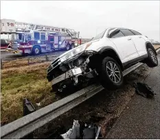  ?? JERRY LARSON/WACO TRIBUNE-HERALD VIA AP ?? A vehicle rests on a barricade as the driver lost control and slid off Highway 6 on Tuesday in Waco, Texas. Winter weather in a wide swath of the United States caused numerous accidents on roads.