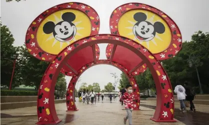  ??  ?? Tourists at Disneytown in Shanghai, China, on 5 May. Photograph: Hu Chengwei/Getty Images