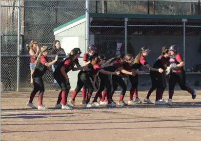  ?? PHOTOS BY BOB MINENNA ?? Hailee Bussard is congratule­d by teammates as she approaches the plate after hitting a two-run homer in the bototm of the sixth inning, capping Clear Lake's 8-2playoff win over Upper Lake on Friday in Lakeport.