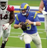  ?? (AP/Ashley Landis) ?? John Wolford passed for 231 yards and rushed for 56 more in his NFL debut, leading the Los Angeles Rams to an 18-7 victory over the Arizona Cardinals for their third postseason berth in four years.
