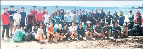  ??  ?? Volunteers after the clean-up exercise at Pandan Beach in Lundu.