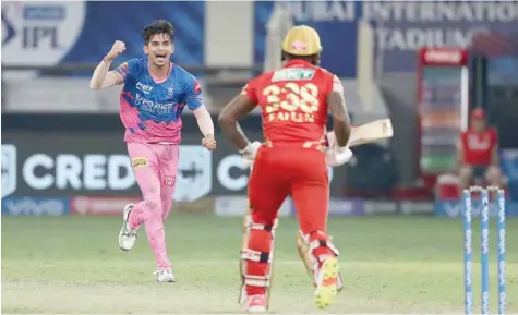  ?? — BCCI ?? Kartik Tyagi of Rajasthan Royals celebrates the wicket of Fabian Allen of Punjab Kings in the final over to win the game.