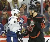  ?? JARED C. TILTON/GETTY IMAGES ?? Tampa Bay’s Nikita Kucherov and Carolina’s Brett Pesce scuffle during the third period of the Lightning’s road loss on Sunday afternoon.