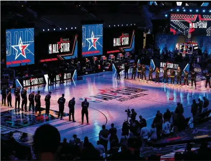  ?? CURTIS COMPTON/CURTIS.COMPTON@AJC.COM ?? Team Durant (left) and Team Lebron pause for a moment of silence for those who have been lost worldwide because of COVID-19 before Sunday night’s NBA All-star Game at State Farm Arena.