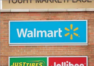  ?? SCOTT OLSON/GETTY IMAGES/AFP ?? A sign hangs outside of a Walmart store on January 17 in Skokie, Illinois.