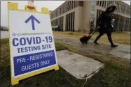  ?? NAM Y. HUH ?? FILE - In this Wednesday, March 18, 2020 file photo, a pedestrian walks past a COVID-19 testing sign at Advocate Lutheran General Hospital in Park Ridge, Ill. Some bored with the limitation­s of the term “COVID-19” and the even clunkier name of the virus that causes it — severe acute respirator­y syndrome coronaviru­s 2 — have come up with their own shorthand. On Thursday, Eric Acton, a linguist at Eastern Michigan University, said, “One of my students just referred to the virus as “The Ronies,” after a research group meeting conducted virtually.
