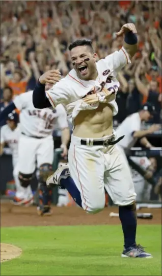  ?? TONY GUTIERREZ — THE ASSOCIATED PRESS ?? Astros' Jose Altuve reacts after scoring the game-winning run during the ninth inning of Game 2 of American League Championsh­ip Series in Houston on Saturday