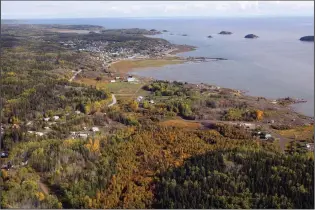  ?? CP PHOTO JEFF MCINTOSH ?? An aerial view of Fort Chipewyan, Alta., on the border of Wood Buffalo National Park is shown on Sept. 19, 2011. A United Nations body that monitors some of the world’s greatest natural glories is in Canada again to assess government responses to ongoing threats to the country’s largest national park, including plans to release treated oilsands tailings into its watershed.