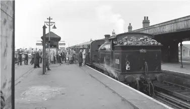  ?? A E Bennett ?? The tail lamp has already been moved to the bunker of ‘H’ class No 31518 as passengers mill around the platform at the former LB&SCR station at New Cross Gate, the first of many reversals on this tour. The station was opened by the London & Croydon Railway on 1 June 1839 as New Cross but it was renamed by the newly-formed Southern Railway on 9 July 1923 to provide a distinctio­n from the nearby former South Eastern Railway station to the east, also inherited at the grouping.