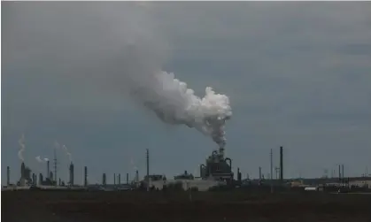  ?? ?? The policy, part of Canada’s plan to reach net-zero by 2050, works by setting a limit and having companies trade emission allowances. Photograph: Bloomberg/Getty Images