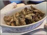  ?? (Arkansas Democrat-Gazette/Eric E. Harrison) ?? Mushroom chunks sauteed in garlic and olive oil make for a shareable appetizer at Mi Paella.