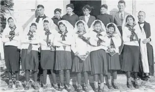  ?? TRUTH AND RECONCILIA­TION COMMISSION ?? Photograph­s of residentia­l school students at confi rmation class in Alberta, above, or in the classroom, right, don’t portray their misery or the often deadly conditions.