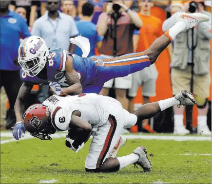  ?? John Raoux ?? The Associated Press Florida’s Chris Thompson, top, hits South Carolina’s Chris Lammons after he caught a punt during a Southeaste­rn Conference game Nov. 12, 2016, in Gainesvill­e, Fla. Thompson was penalized for targeting and was ejected from the game.