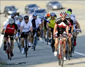  ?? John Heller/Post-Gazette ?? Members of the West Hills Road Riders climb a hill at Settlers Ridge in front of traffic. The club, founded five years ago, meets twice weekly for 25- to 30-mile rides.