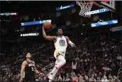  ?? DAVID J. PHILLIP — THE ASSOCIATED PRESS ?? The Warriors' Jonathan Kuminga goes up for a dunk as the Houston Rockets' Daishen Nix (15) watches during the second half Monday in Houston. The Warriors won 121-108.